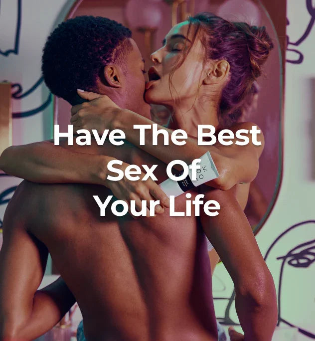 Couple being intimate with the woman holding coconut oil lube.