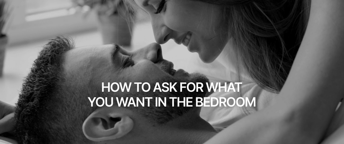 Close-up of woman on top of man in bed