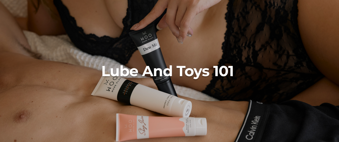 Person on a bed wearing black lace lingerie while holding silicone lubricant
